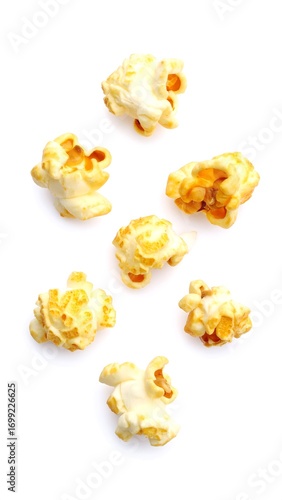 Popcorn kernels scattered on white background