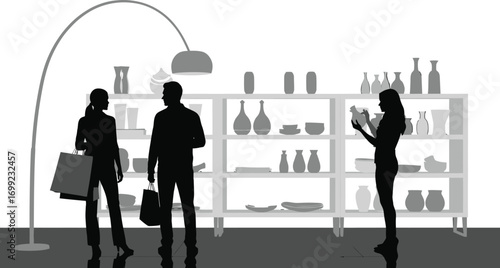 People shopping for home decor in a modern showroom, browsing shelves with vases and pottery