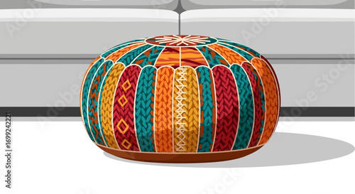 Vibrant Knitted Pouf with Ethnic Pattern Near a Modern Sofa Backdrop