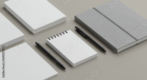 Minimalist office setup featuring notebooks pens and neutral background tone