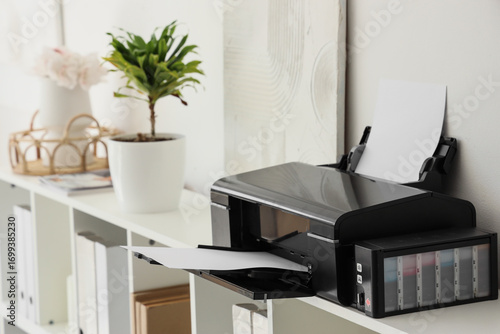 Modern printer on shelf in ...