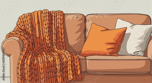 A cozy tan couch with a chunky orange knit blanket and two throw pillows, one orange and one white.