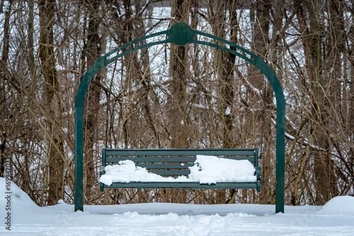 Snow covered park swing