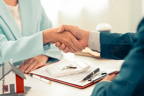 Canvas Print Home sales representative shakes hands with the client and negotiates successfully, and buying and selling handshakes sign the contract and successfully complete the purchase of the home