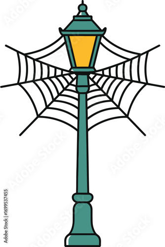 Teal street lamp with yellow light and black spiderweb