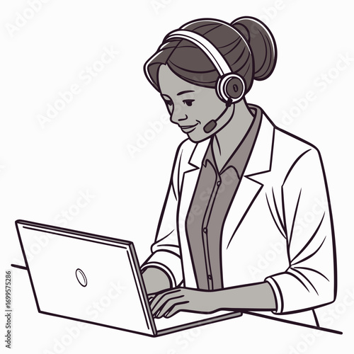 Smiling woman wearing headset and blazer working on a laptop computer at her desk