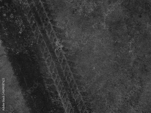 Close up black tire marks on cement floor.