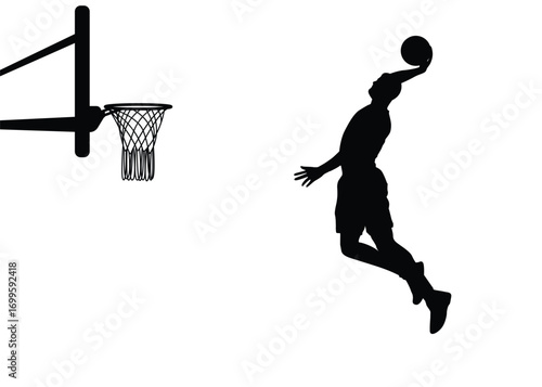 Silhouette of a basketball player in a jump shot position, shooting the ball into the hoop. Male basketball player, isolated background.