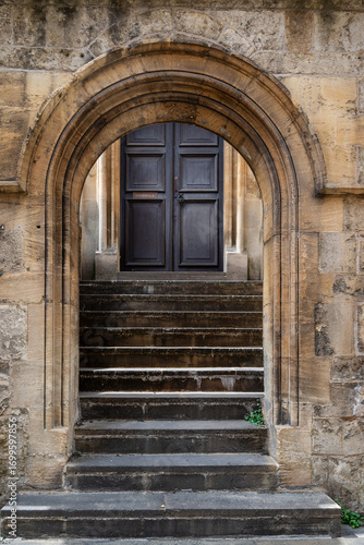 old gate door and stairs made of stone - architectural details of Oxford University