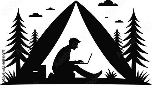 Silhouette of a person working on a laptop inside a tent at night
