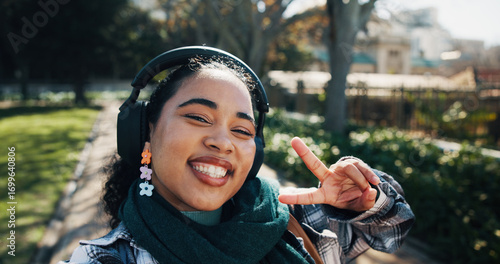 Obraz na płótnie Headphones, peace sign and selfie with girl student on campus for development or education