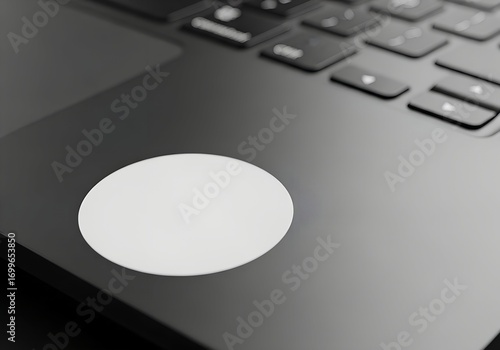 rounded black white sticker on dark grey laptop