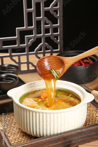 Chinese Chicken Lemongrass Soup with Dried Ingredients Being Served in Traditional Bowl