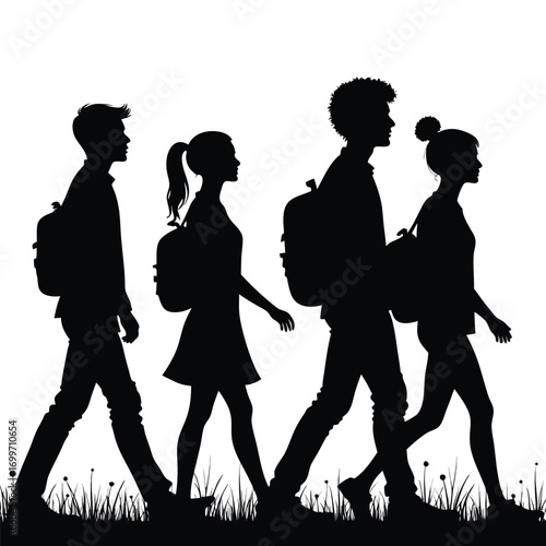 Four students walking with backpacks in silhouette
