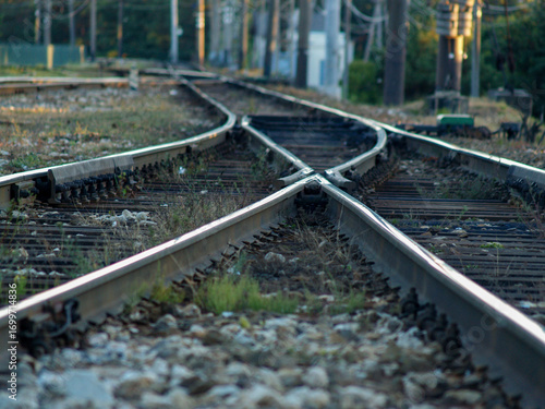 Close-up view of railway switch and rails converging.