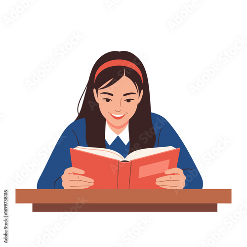 A young student joyfully engrossed in reading an open book at a wooden desk