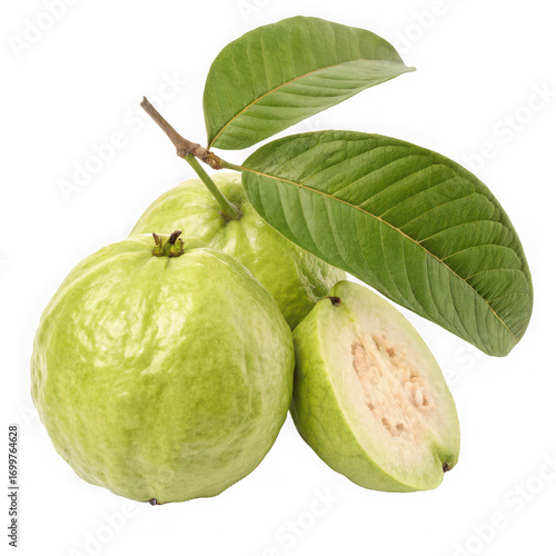 Close up of three green guavas with leaves and a cut guava on black background