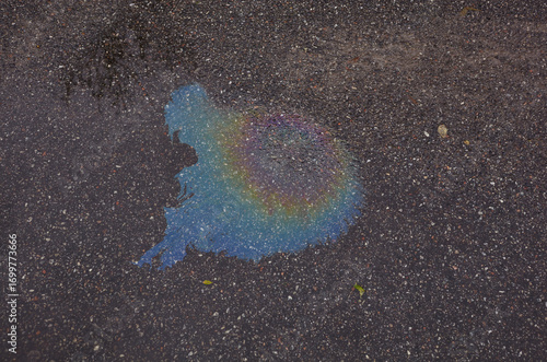 Color gasoline fuel spot on asphalt. Environmental pollution in the city