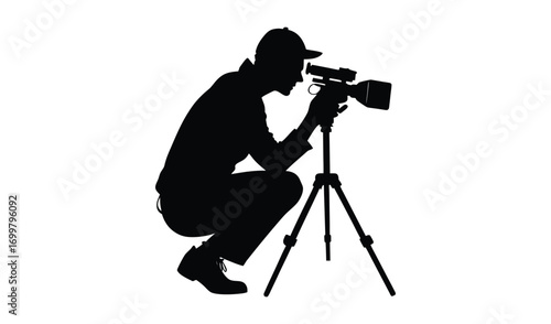 Silhouette of a person filming with a video camera on a tripod