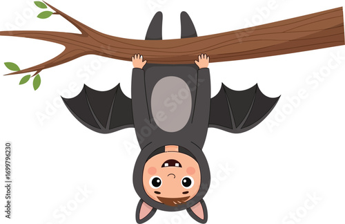 Adorable kid in bat costume hangs upside down on a branch