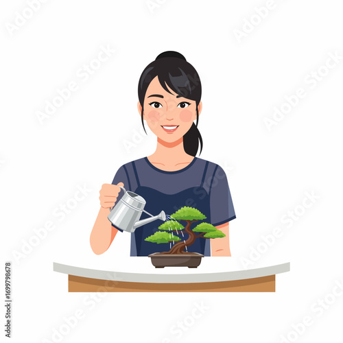 A smiling young woman with dark hair watering a small bonsai tree on a light-colored table.