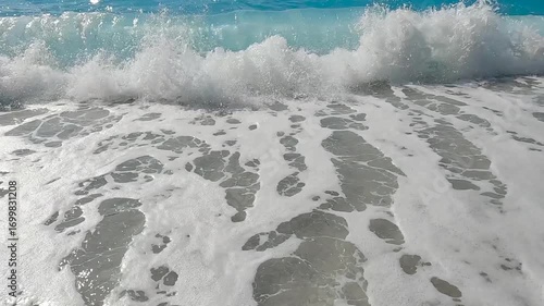 Foaming big waves splashing on the pebble beach. Rough sea. Slow motion.  