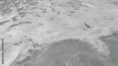 Foaming big waves splashing on the pebble beach. Rough sea.
