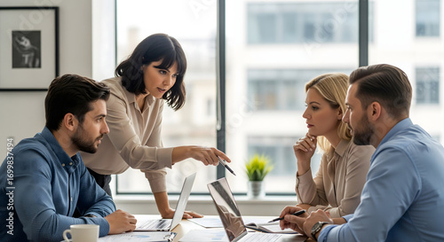 creative professionals analyzing business data together in office meeting using financial charts printed paperwork and computer technology tools work and office life business activity photo