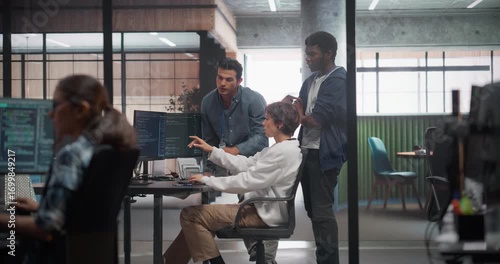 Team of Three Talented Software Engineers Use Computer to Discuss a Technological Project in Modern Industrial Office. Group of Male and Female Programmers Work in Research and Development Center