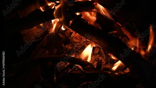 Close up of flame of bonfire burning in the wood. A large fire that is made outside to burn unwanted things, or for pleasure.