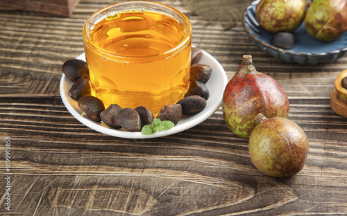 Wild Camellia Tea Oil with Seeds on Wooden Table - Natural Harvest Cooking Ingredient