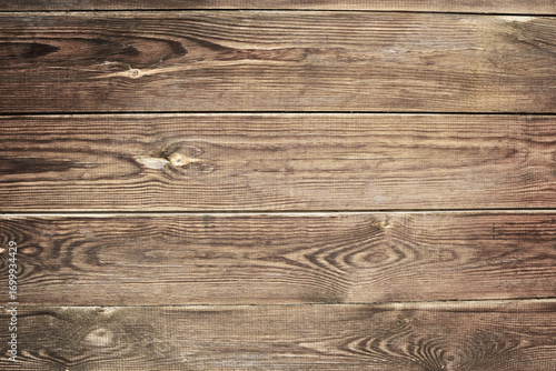 Brown distressed rustic wood grain with twig imperfections and scratches. Overhead view of old dark brown wooden table. Texture or abstract background. Place for text.