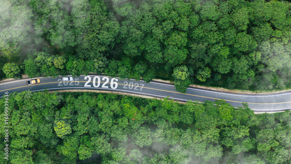 Naklejka premium Aerial top view road in forest with car to start the new year 2026 Goal plan action, Business target and growth strategy. Business annual plan and development for achieving goals and success.