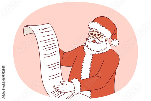 Santa claus reads wish list and rejoices at approaching new year or christmas holidays. Santa claus in red clothes is preparing to deliver gifts for children, on eve of december festives