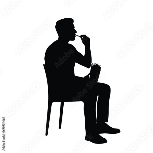 A black silhouette of a person sitting on a chair, enjoying a snack of french fries. This image represents casual dining, fast food, and a relaxed moment of eating.