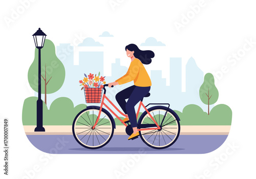 A woman rides a bicycle through a picturesque park with a basket full of flowers
