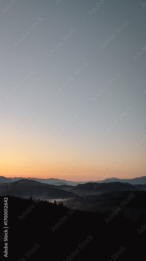 Fototapeta premium mMajestic mountain sunrise with mist and forest