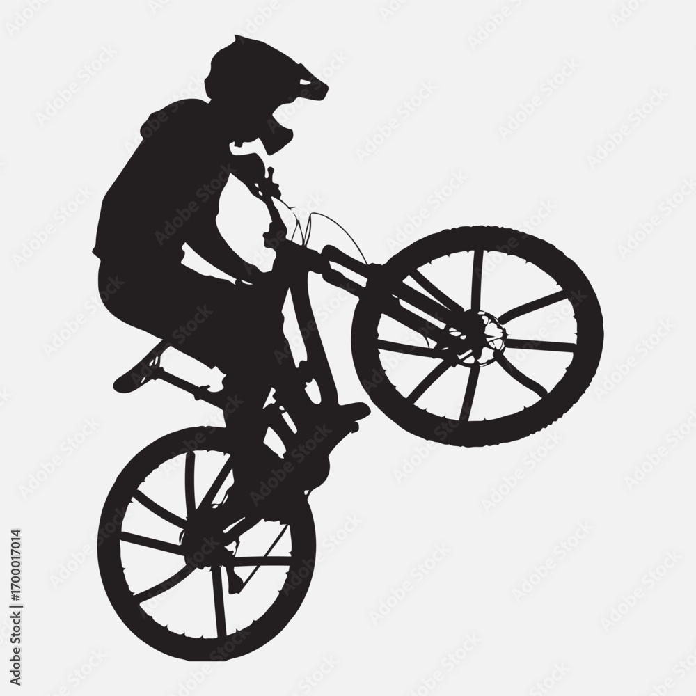 Fototapeta premium Black silhouette of cyclist performing a wheelie bicycle