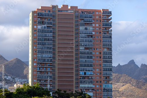 Residential building with a mountain backdrop creating contrast
