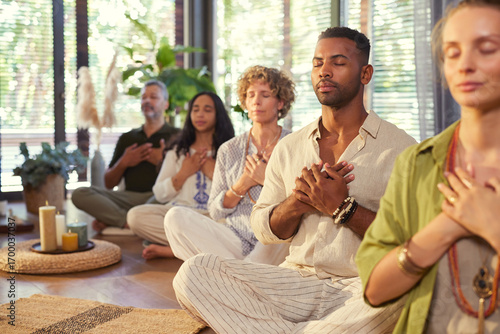 Wallpaper Mural Multiethnic group of people practicing meditation with hands on heart Torontodigital.ca