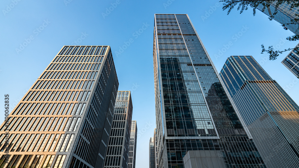 Obraz premium Modern skyscrapers in an urban business district under a clear blue sky