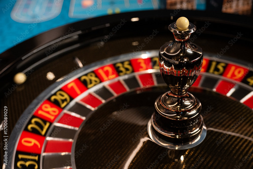 Obraz premium Roulette Wheel Close-up Casino Game with Ball and Numbers