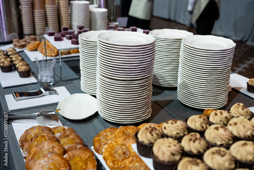 Catering banquet table with assorted snacks, desserts, pastries and appetizers, luxury food service arrangement for corporate event, wedding or festive celebration