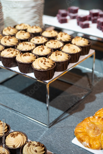 Catering banquet table with assorted snacks, desserts, pastries and appetizers, luxury food service arrangement for corporate event, wedding or festive celebration