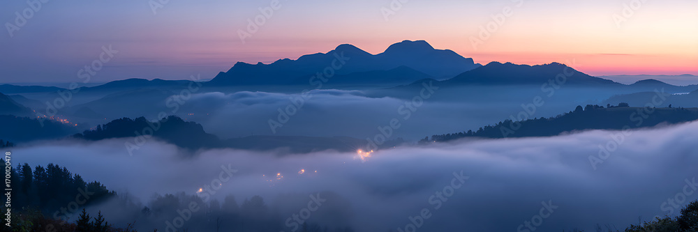 Fototapeta premium Majestic mountain range reflecting in calm water during a serene sunset sky