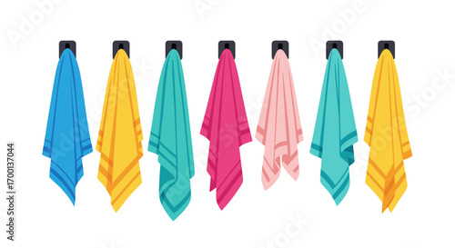 Set of various colorful bathroom towels hanging on hooks displayed against a white background