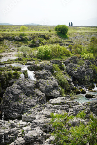 River Flowing Through Rocks Forming Small Waterfalls