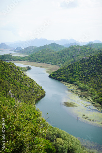 Aerial View of River Meander Surrounded by Green Mountains