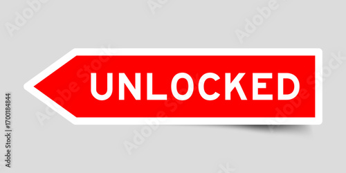 Red color arrow shape sticker label with word unlocked on gray background