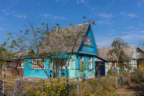 A small wooden country house on a summer street.